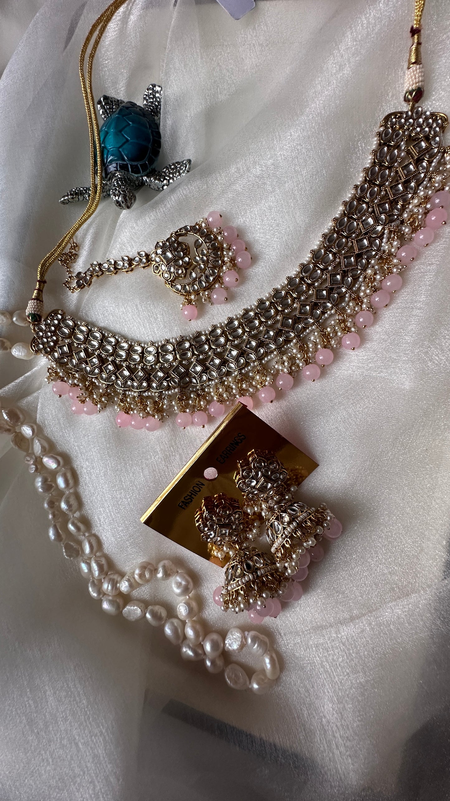 Kundan choker or necklace set with earrings and tikka baby pink