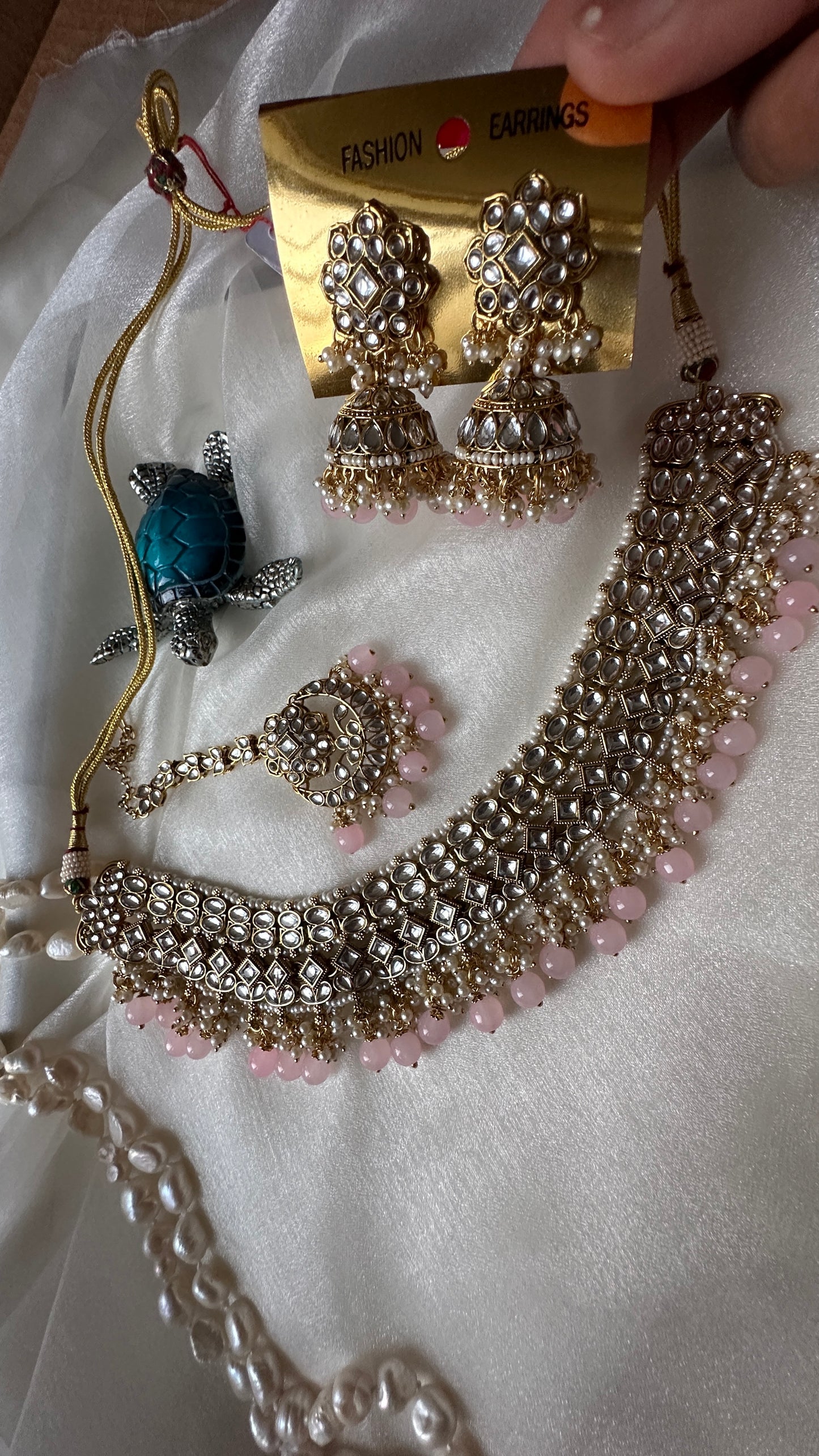 Kundan choker or necklace set with earrings and tikka baby pink