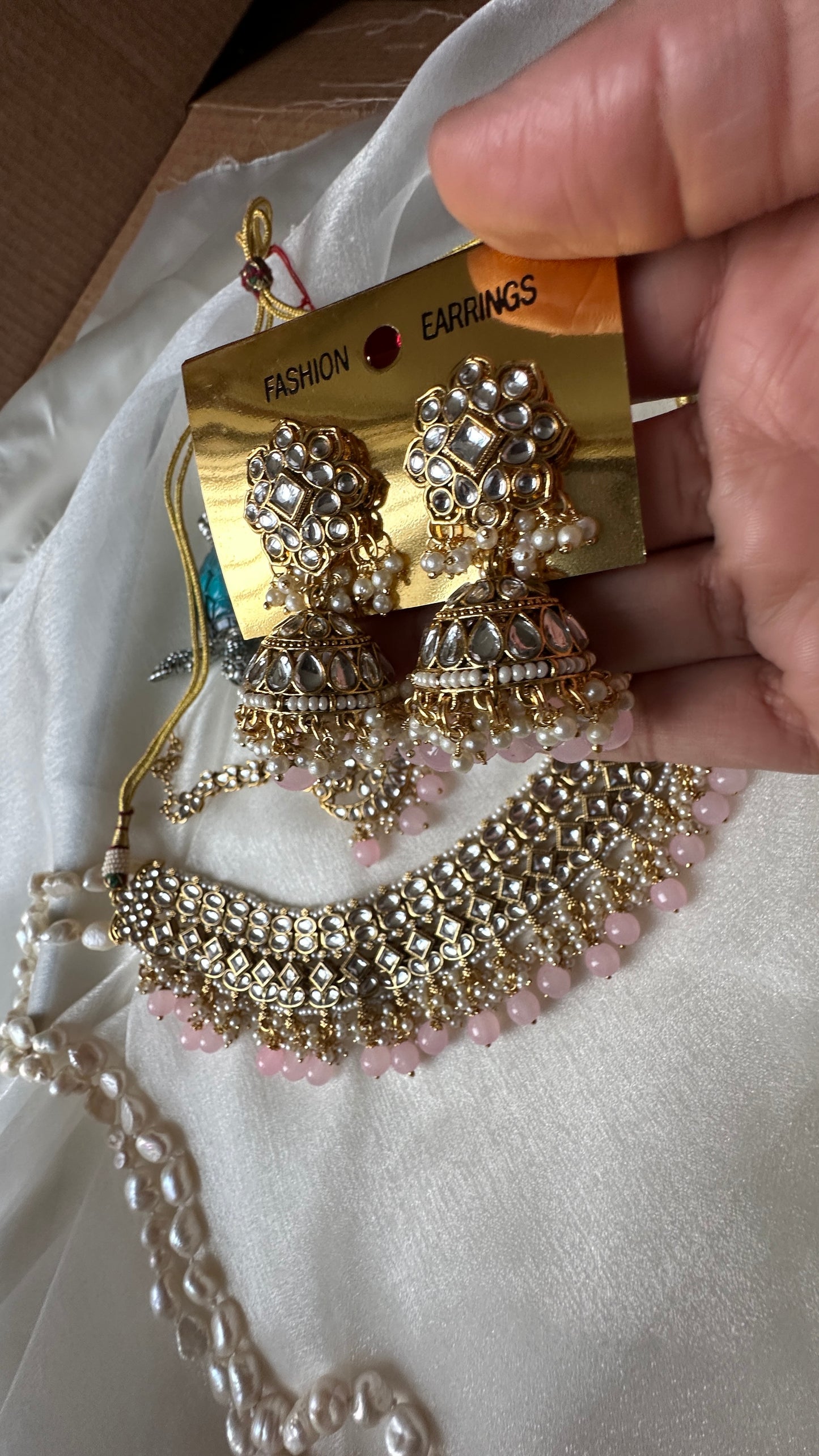 Kundan choker or necklace set with earrings and tikka baby pink