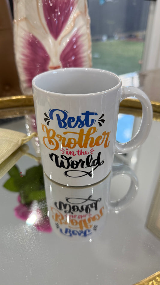 White mug with colorful text 'Best Brother in the World' on a reflective surface.