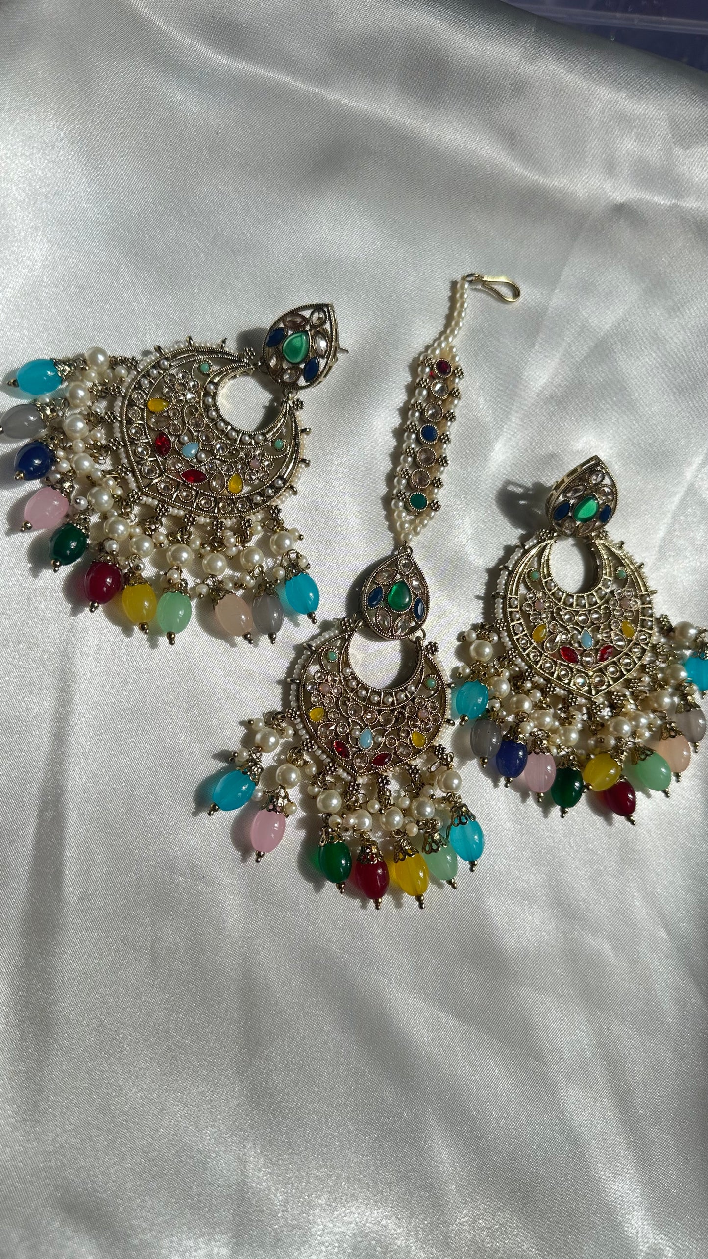 Reverse ad earrings and tikka multi