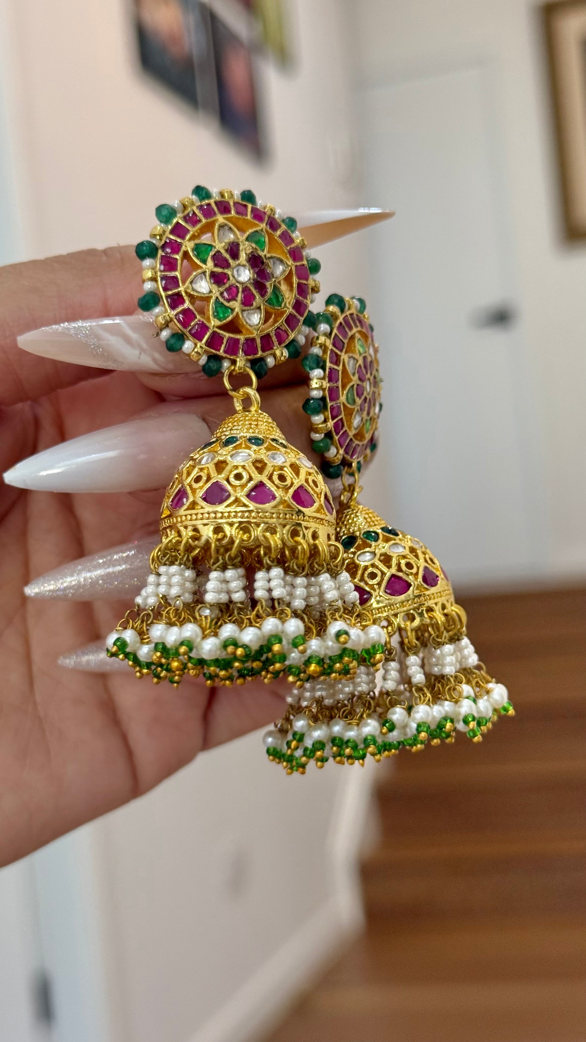 Gold-plated Pachi Kundan Jhumka with red and green stones, perfect for bridal and festive occasions