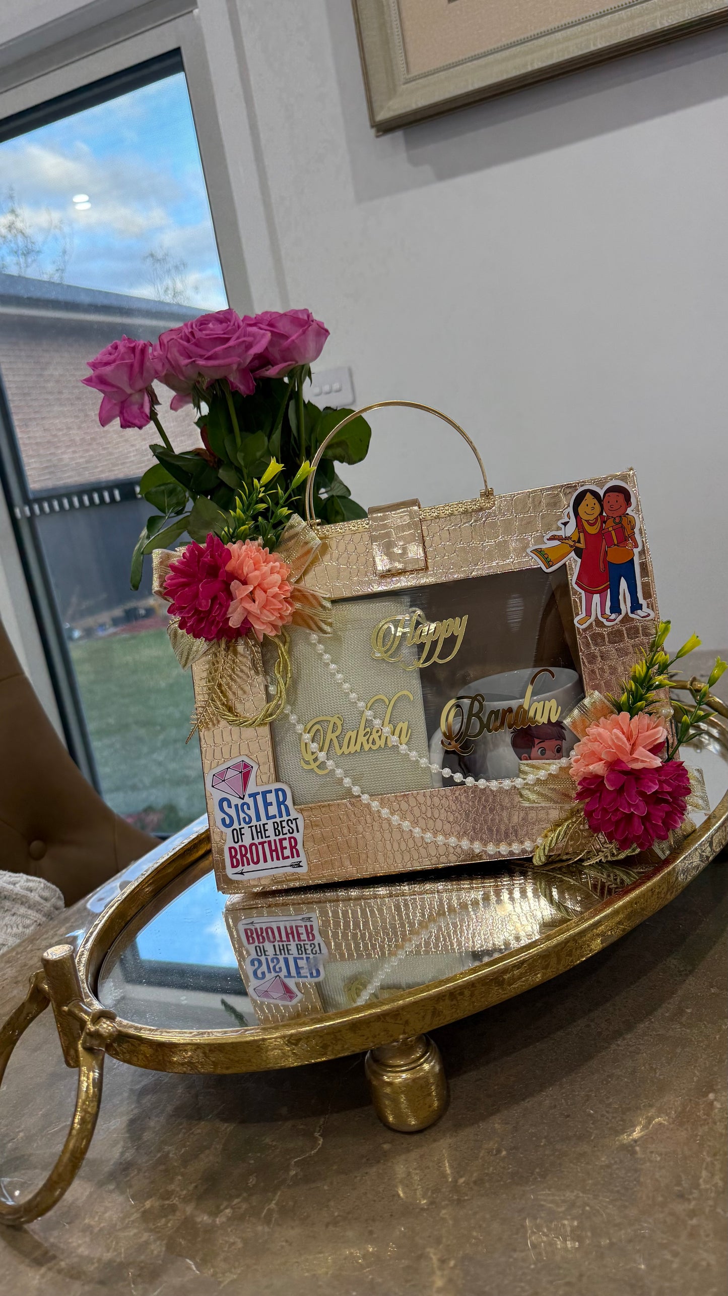 Premium Rakhi gift box with gold foil rakhi, dry fruits, diya, and festive ribbon