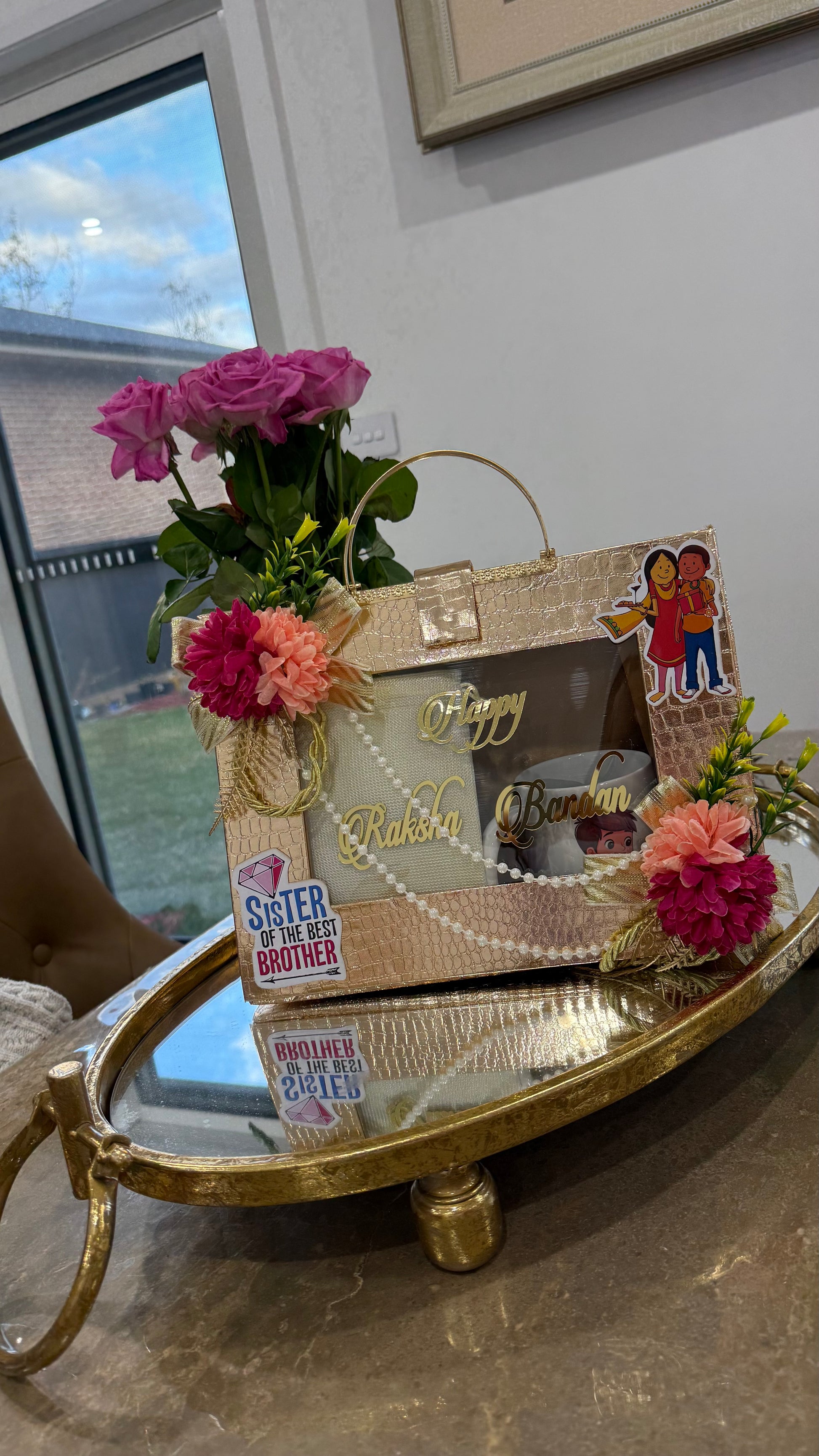 Premium Rakhi gift box with gold foil rakhi, dry fruits, diya, and festive ribbon